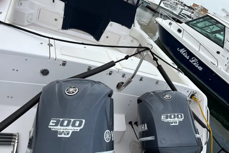 Slide: The Image of 2004 Grady-White Express 330 boat with twin Yamaha 300 V6 engines docked at marina. - 3