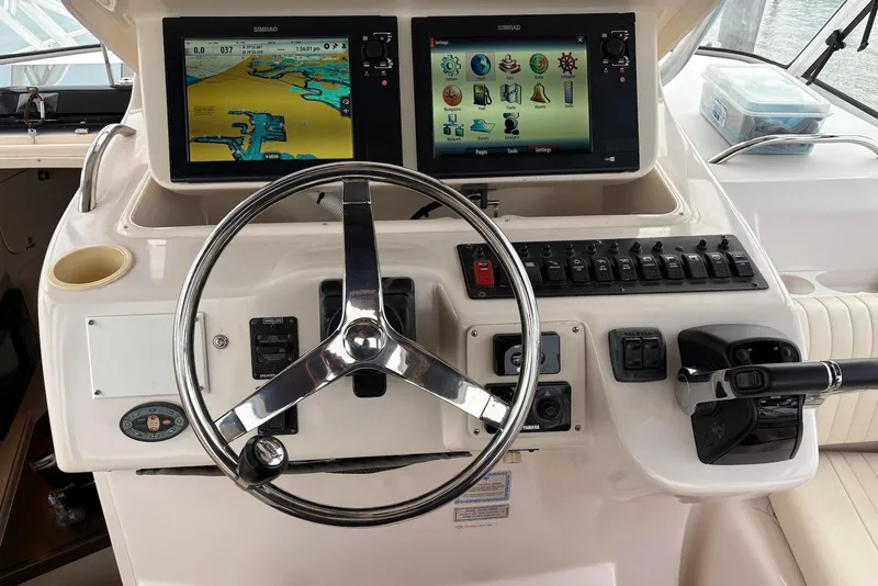 Slide: The Image of Control panel of a 2004 Grady-White Express 330 boat with navigation screens. - 5