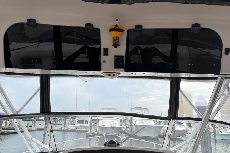 Slide: The Image of 2004 Grady-White Express 330 boat interior with marina view through windshield. - 7