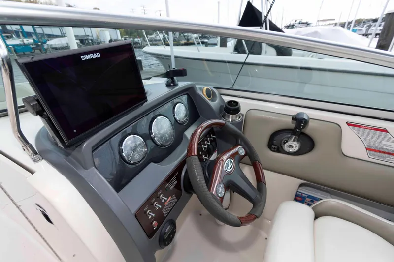 Slide: The Image of 2007 Sea Ray 260 Sundeck dashboard with steering wheel and navigation system. - 7