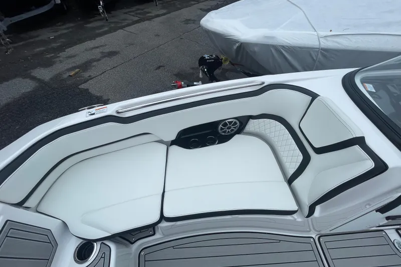 Slide: The Image of 2026 Yamaha Boats 252S interior with white cushioned seating and speaker system. - 12