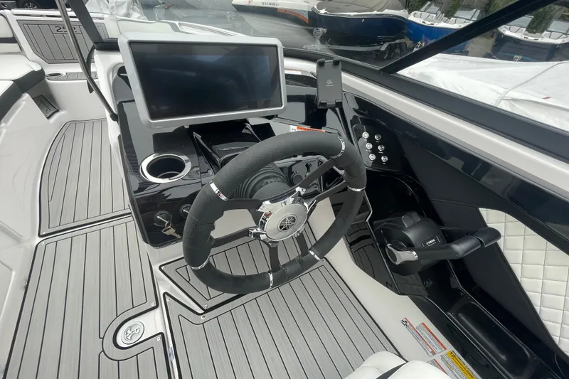 Slide: The Image of 2026 Yamaha Boats 252S cockpit with steering wheel and touchscreen display. - 15