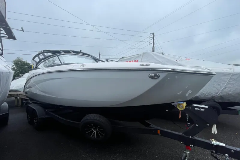 Slide: The Image of 2026 Yamaha Boats 252S on trailer, sleek design, parked outdoors. - 21