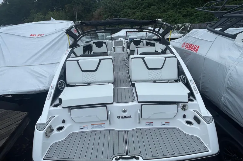 Slide: The Image of 2026 Yamaha Boats 252S, sleek design, luxury seating, docked with protective covers. - 4