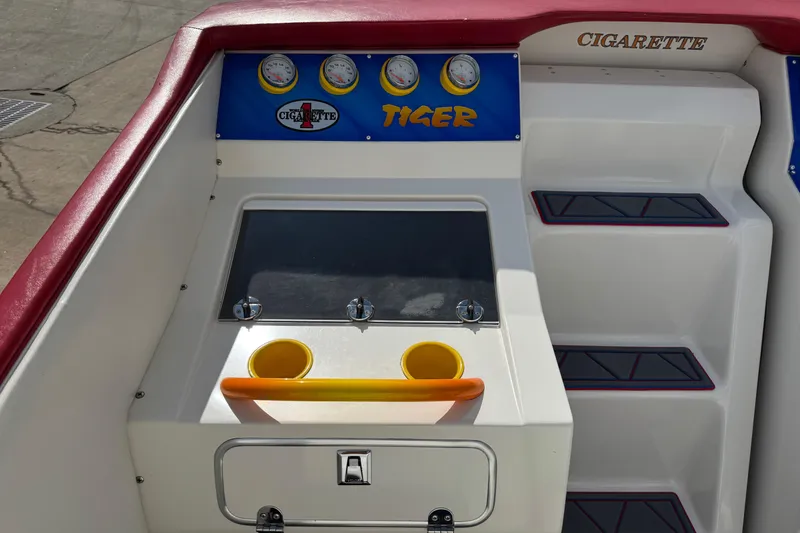 Slide: The Image of 2004 Cigarette 42 Tiger boat dashboard with gauges and storage compartments. - 12