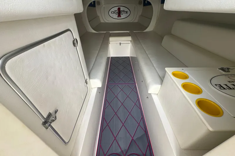 Slide: The Image of Interior of 2004 Cigarette 42 Tiger boat with white seating and storage compartments. - 15