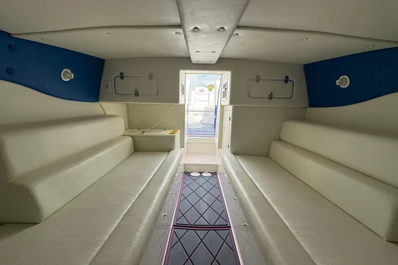Slide: The Image of Interior of 2004 Cigarette 42 Tiger boat with white seating and blue accents. - 18