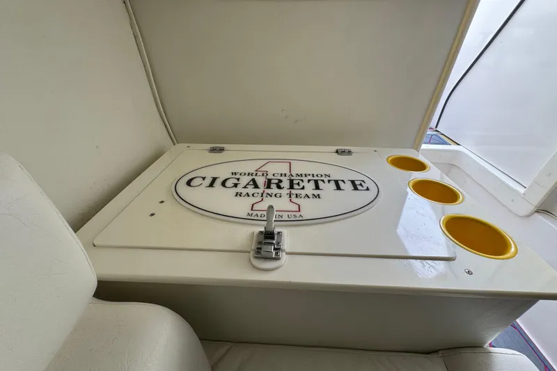 Slide: The Image of 2004 Cigarette 42 Tiger boat interior with branded storage compartment and cup holders. - 19