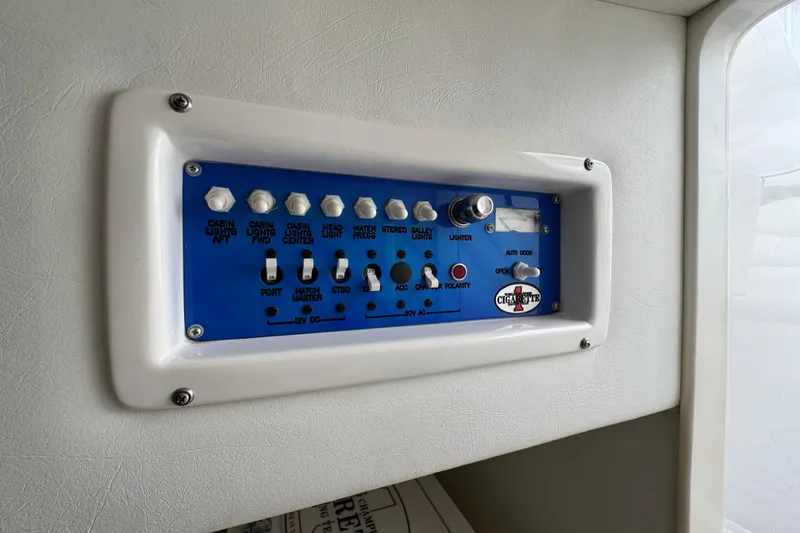 Slide: The Image of Control panel of a 2004 Cigarette 42 Tiger boat with various switches and indicators. - 20