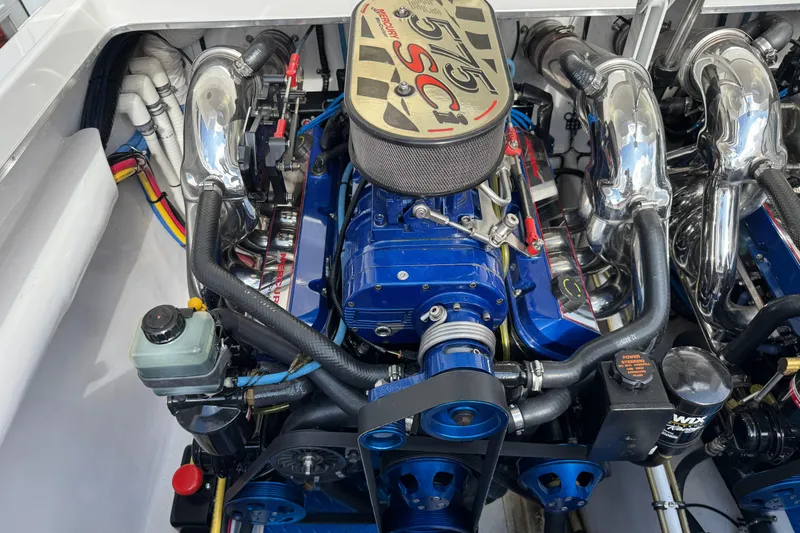 Slide: The Image of Engine of a 2004 Cigarette 42 Tiger boat, featuring blue and chrome components. - 22