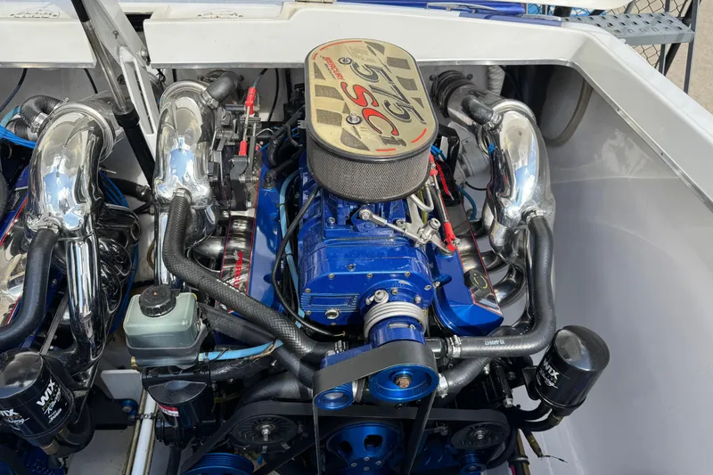 Slide: The Image of 2004 Cigarette 42 Tiger engine compartment with high-performance components and chrome detailing. - 23