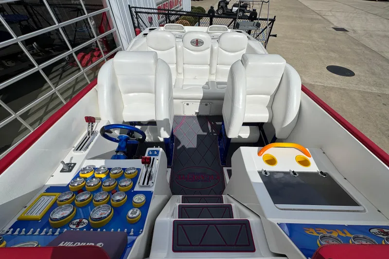 Slide: The Image of 2004 Cigarette 42 Tiger boat interior with white seats, colorful dashboard, and steering wheel. - 8