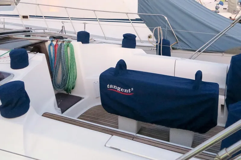Slide: The Image of 2002 Jeanneau Sun Odyssey 45.2 yacht cockpit with covered equipment and colorful ropes. - 11