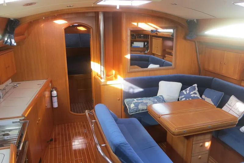 Slide: The Image of Interior of 2002 Jeanneau Sun Odyssey 45.2 yacht with cozy seating and wooden finishes. - 14