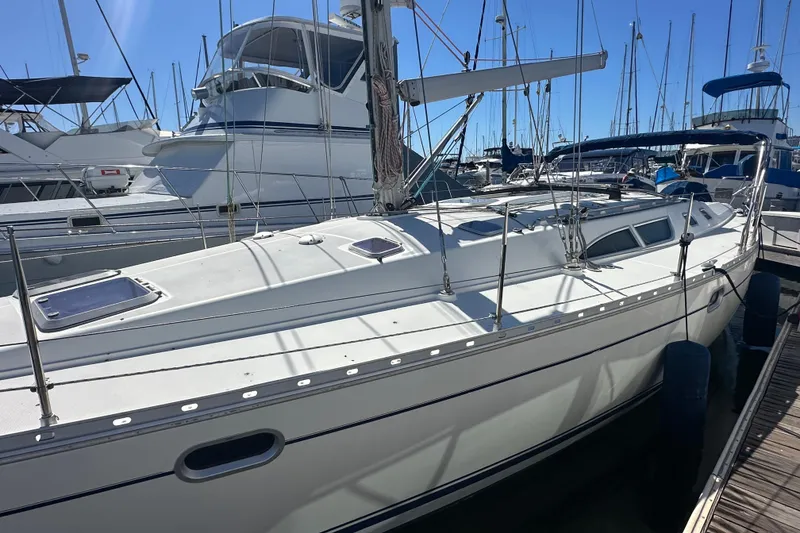 Slide: The Image of 2002 Jeanneau Sun Odyssey 45.2 sailboat docked in a marina under clear blue skies. - 18