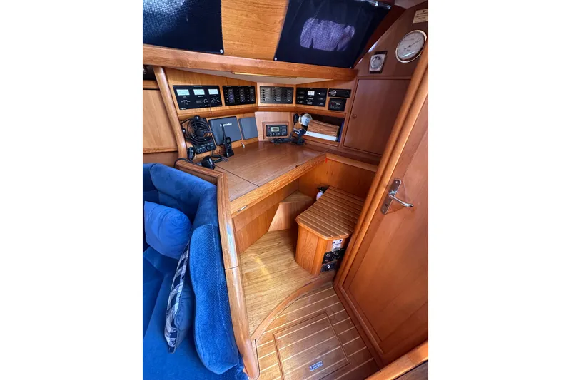 Slide: The Image of Navigation station of 2002 Jeanneau Sun Odyssey 45.2 with wooden interior and control panels. - 20