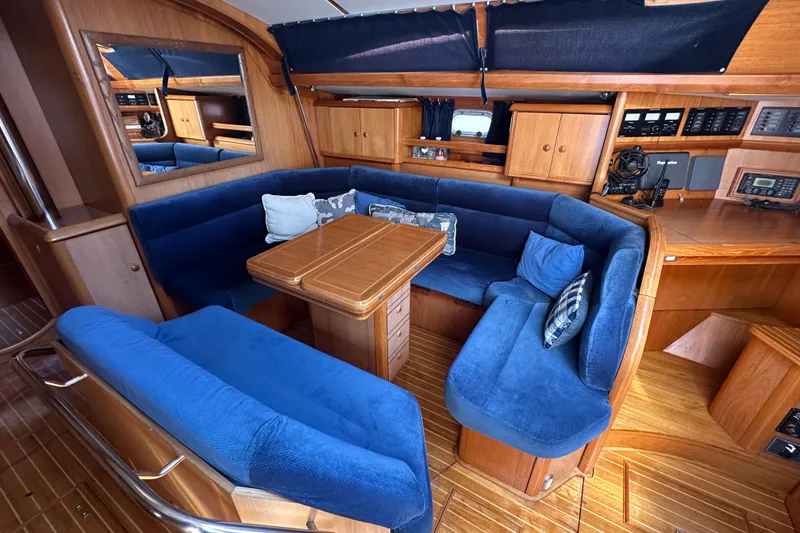 Slide: The Image of Luxurious interior of 2002 Jeanneau Sun Odyssey 45.2 yacht with blue seating and wooden finishes. - 22