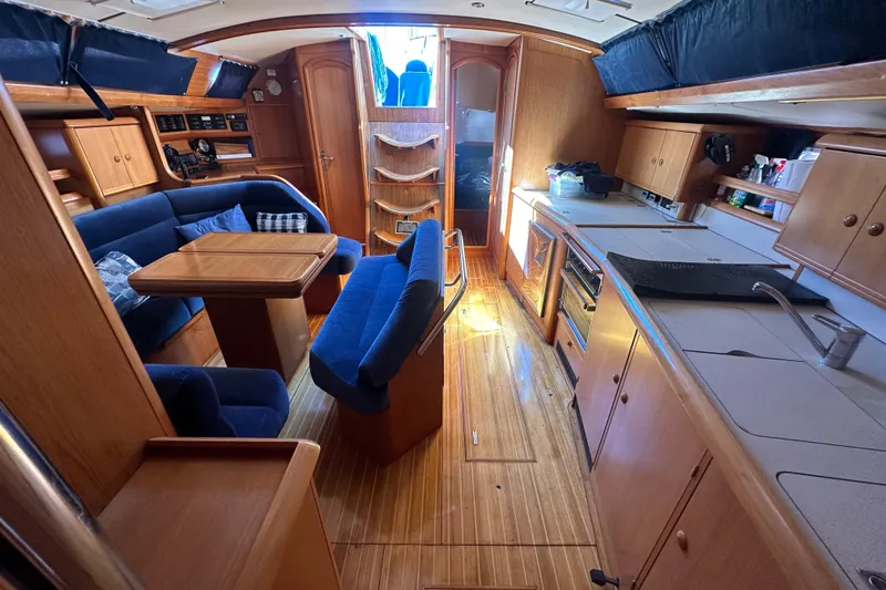 Slide: The Image of Interior of 2002 Jeanneau Sun Odyssey 45.2 yacht with wood finish and blue seating. - 26