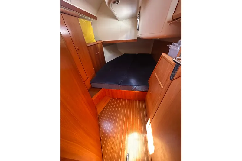 Slide: The Image of 2002 Jeanneau Sun Odyssey 45.2 cabin interior with wooden finish and cozy bedding. - 30