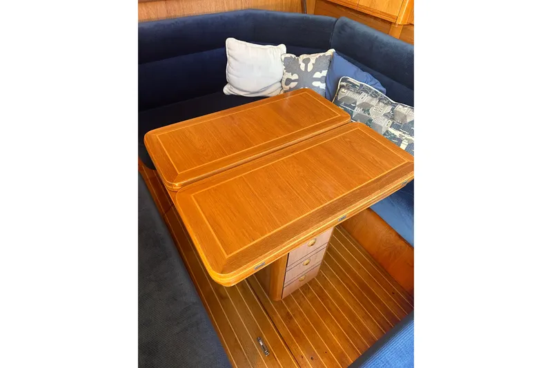 Slide: The Image of Interior of 2002 Jeanneau Sun Odyssey 45.2 with wooden table and blue seating. - 34