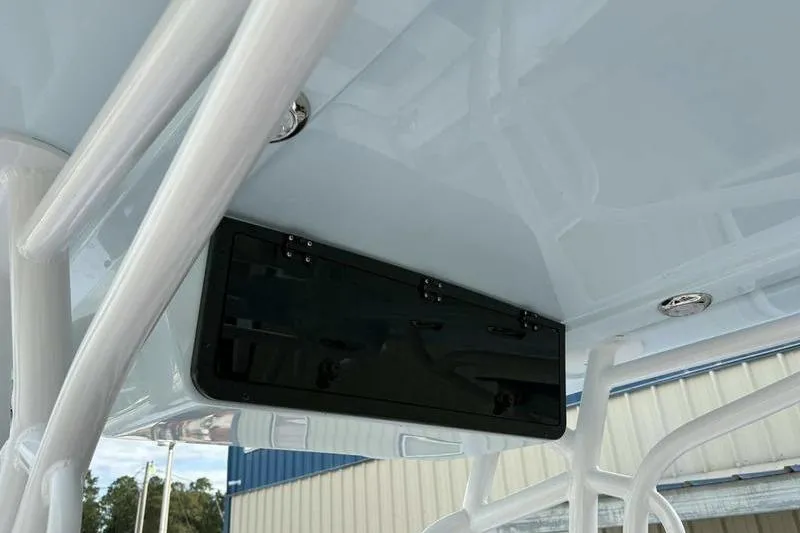 Slide: The Image of 2026 Blazer Bay 2700 Hybrid boat console with storage compartment and white framework. - 10