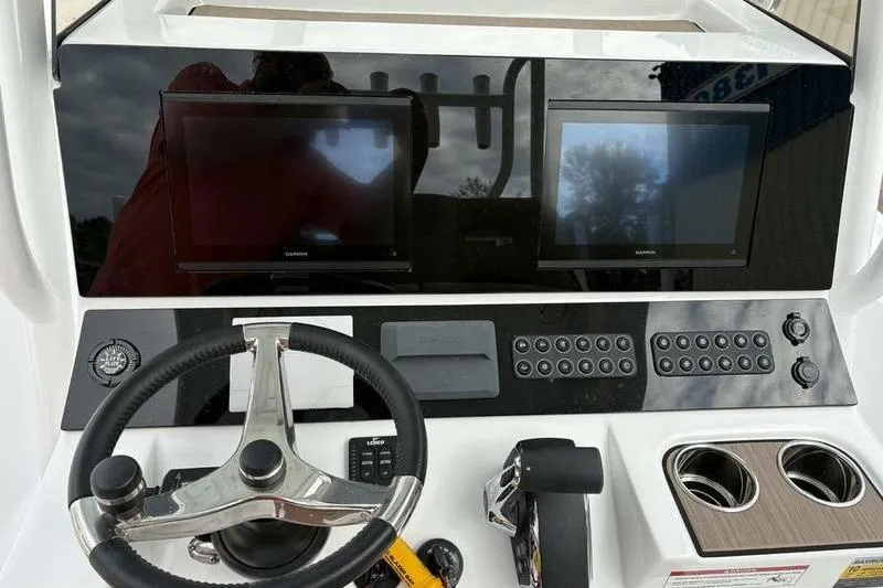 Slide: The Image of 2026 Blazer Bay 2700 Hybrid boat dashboard with dual screens and steering wheel. - 11