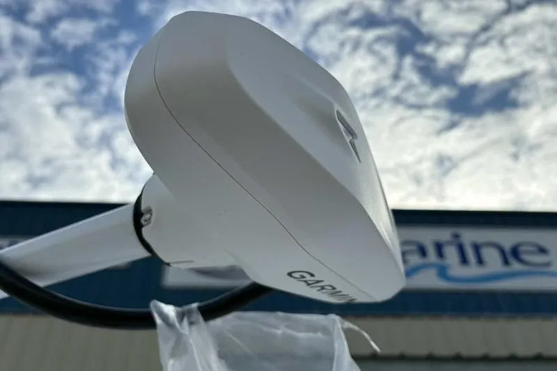 Slide: The Image of Garmin marine device on Blazer Bay 2700 Hybrid, 2026 model, against cloudy sky. - 14