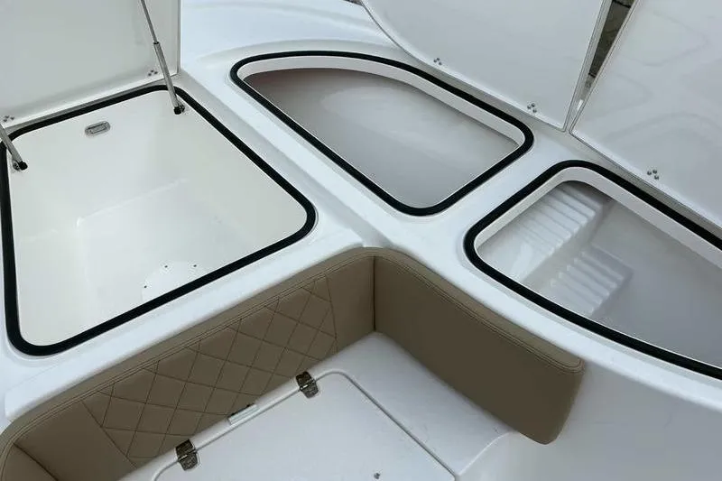 Slide: The Image of 2026 Blazer Bay 2700 Hybrid boat storage compartments with cushioned seating. - 15