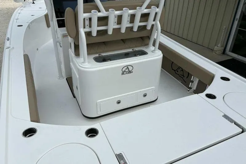 Slide: The Image of 2026 Blazer Bay 2700 Hybrid boat interior with rod holders and storage compartments. - 20