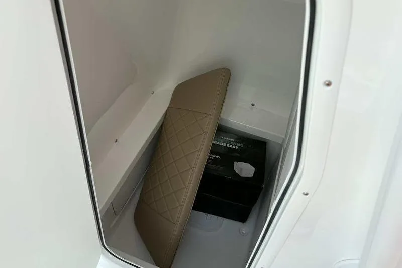 Slide: The Image of Storage compartment in 2026 Blazer Bay 2700 Hybrid boat with cushion and box. - 23