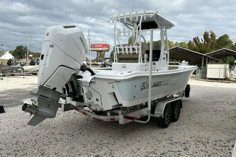 Slide: The Image of 2026 Blazer Bay 2700 Hybrid boat on trailer, featuring a powerful outboard motor. - 5