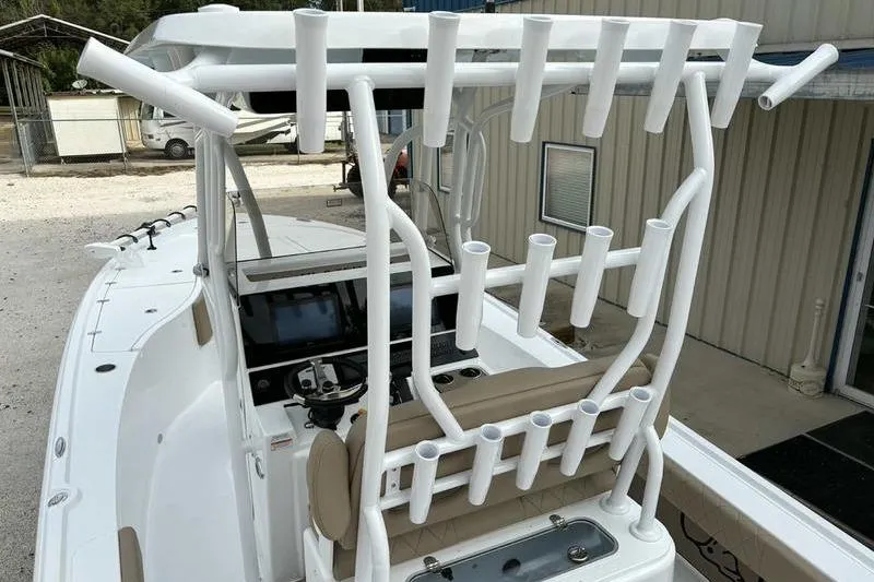 Slide: The Image of 2026 Blazer Bay 2700 Hybrid boat with rod holders and modern dashboard. - 8