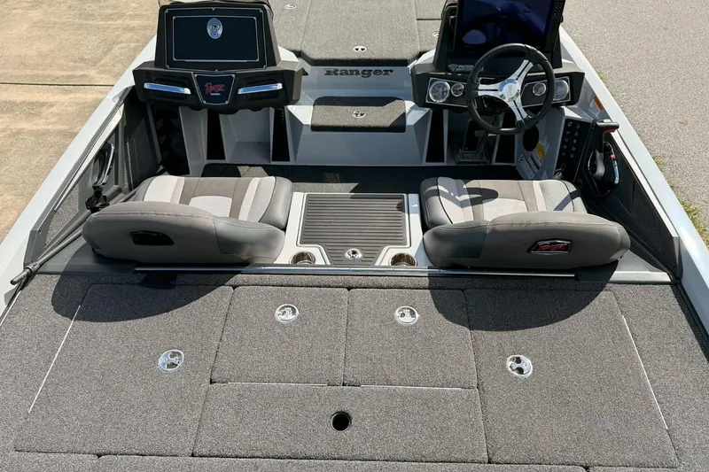 Slide: The Image of 2022 Ranger Z518 boat interior with dual seats, steering wheel, and control panel. - 3