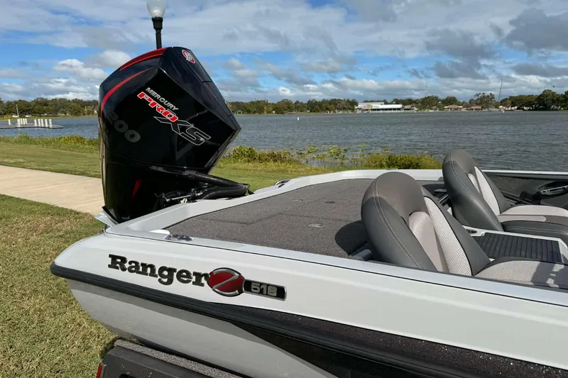 Slide: The Image of 2022 Ranger Z518 boat with Mercury Pro XS engine by a scenic lake. - 9