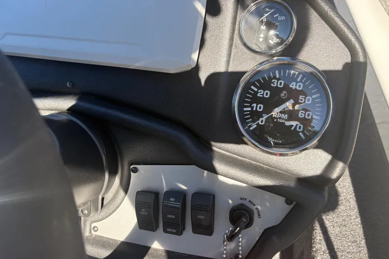 Slide: The Image of Control panel of 2022 Boomeranger 198P with RPM gauge and switches. - 10