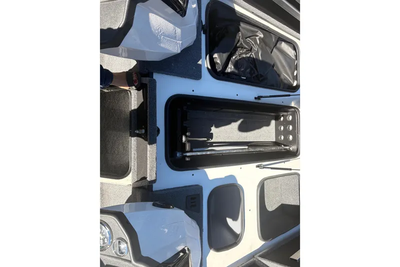 Slide: The Image of 2022 Boomeranger 198P boat interior with open storage compartments and visible dashboard. - 12