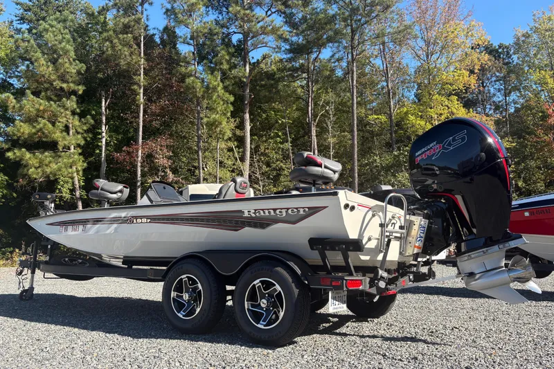 Slide: The Image of 2022 Boomeranger 198P boat with Mercury Pro XS engine, parked outdoors. - 2
