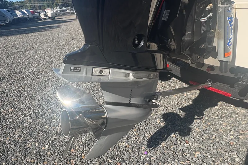 Slide: The Image of Close-up of a 2022 Boomeranger 198P boat propeller on gravel surface. - 4