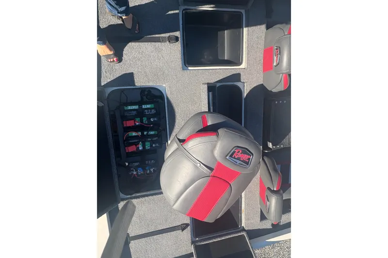 Slide: The Image of 2022 Boomeranger 198P boat interior with red and gray seats, battery compartment open. - 5