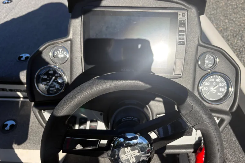 Slide: The Image of Steering wheel and dashboard of 2022 Boomeranger 198P boat with gauges and display. - 8