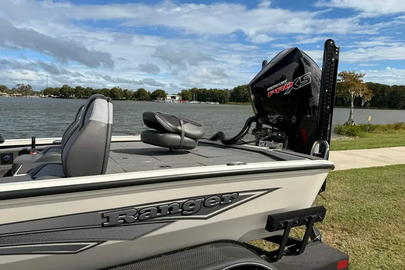 Slide: The Image of 2025 Ranger ALPHA 208 boat with Mercury Pro XS engine by a lake. - 2