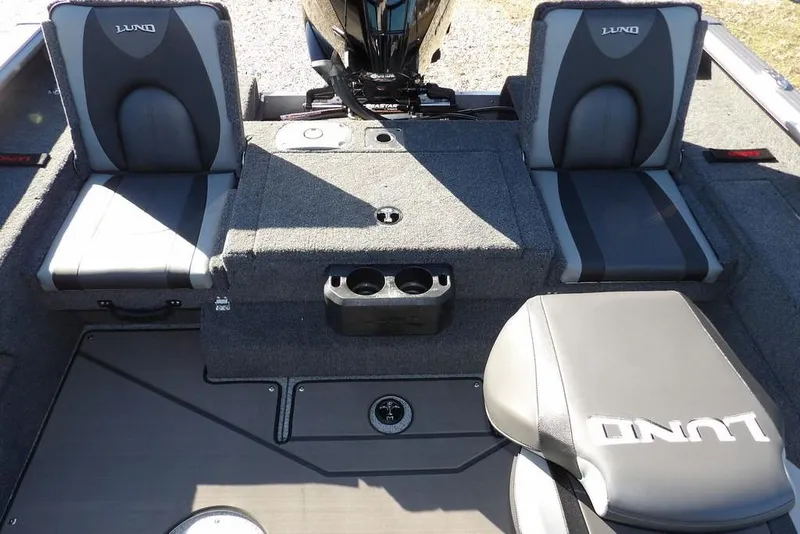 Slide: The Image of 2026 Lund 2075 Impact XS boat interior with seating and storage compartments. - 11