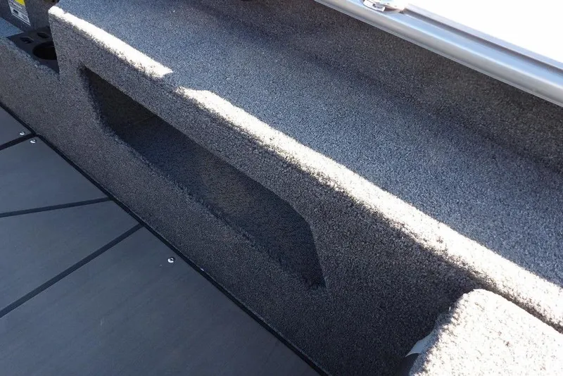 Slide: The Image of Interior view of 2026 Lund 2075 Impact XS boat with carpeted storage area. - 20