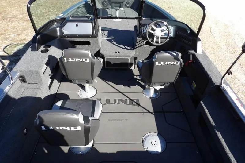 Slide: The Image of 2026 Lund 2075 Impact XS boat interior with seating and steering wheel. - 21