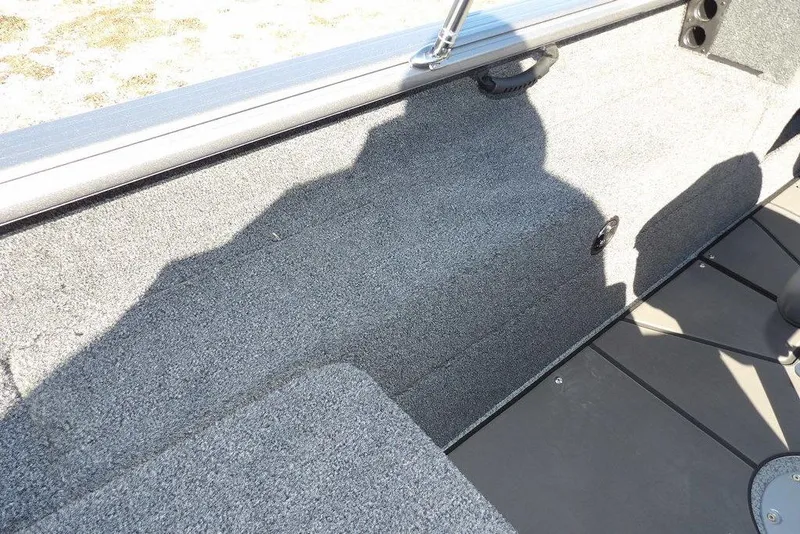 Slide: The Image of Interior view of 2026 Lund 2075 Impact XS boat with gray carpeted finish. - 22
