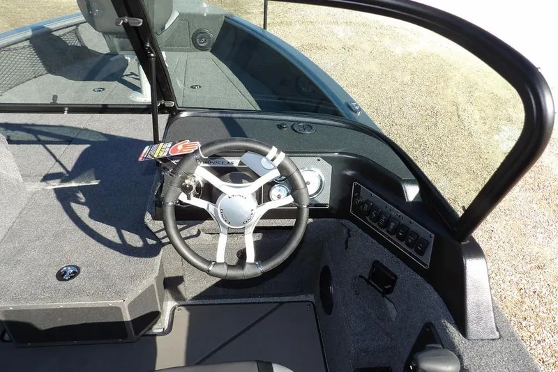 Slide: The Image of 2026 Lund 2075 Impact XS boat cockpit with steering wheel and control panel. - 23