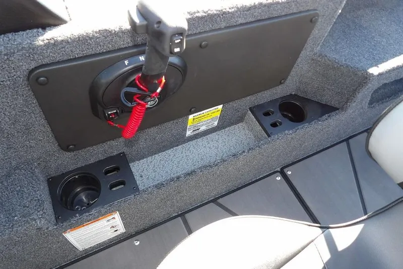 Slide: The Image of 2026 Lund 2075 Impact XS boat interior with control panel and cup holders. - 24