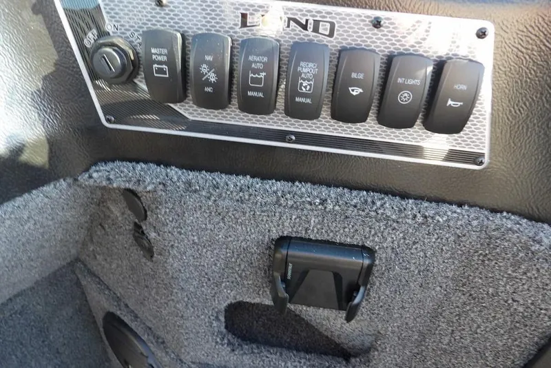 Slide: The Image of Control panel of 2026 Lund 2075 Impact XS boat with various switches. - 25