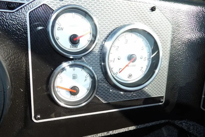 Slide: The Image of Dashboard gauges of 2026 Lund 2075 Impact XS boat, showing trim, RPM, and fuel levels. - 26