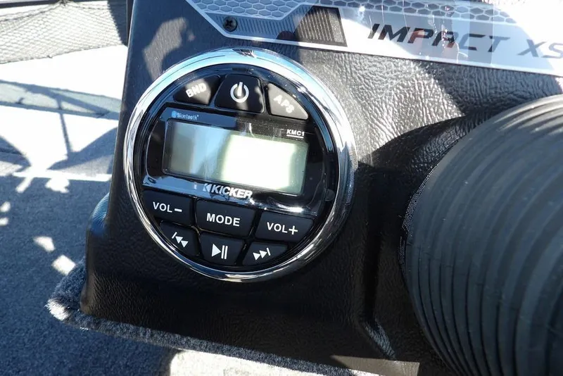 Slide: The Image of 2026 Lund 2075 Impact XS boat dashboard with Kicker audio system controls. - 27